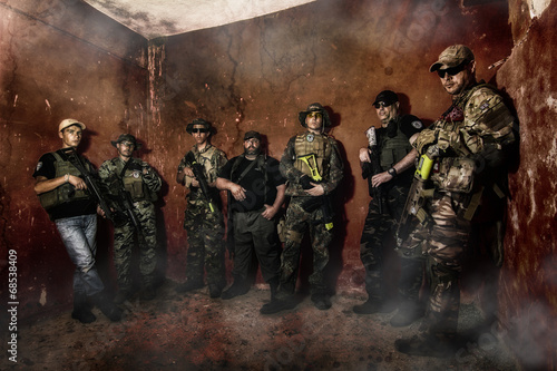 Airsoft group team in daytime action in pose