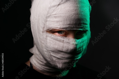 Infected sick girl with a bandage on her head photo