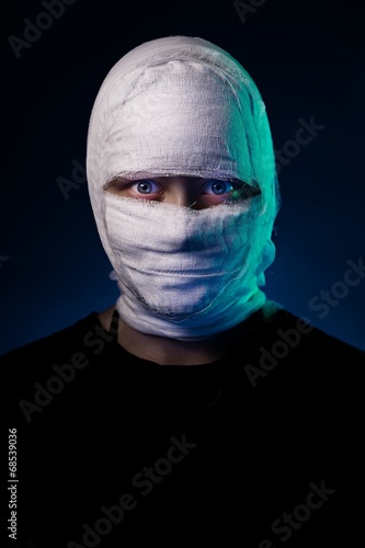 Infected sick girl with a bandage on her head photo