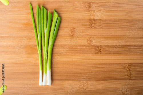 Spring green onion on wooden board