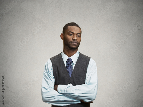 Portrait Annoyed, sad, offended man on grey wall background 