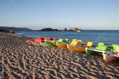 colorful paddle boats on seashore