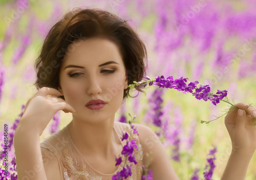 Portrait of beautiful young woman with makeup in fashion clothes on hature photo