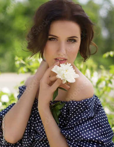 Portrait of beautiful young woman with makeup in fashion clothes on hature photo