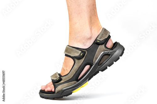 Men's foot in sandals on a white background