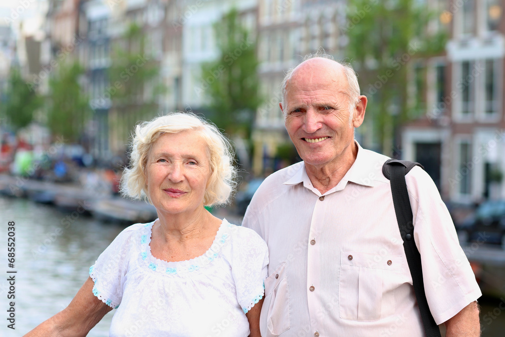 Fototapeta premium Active senior couple enjoying canal views in Amsterdam