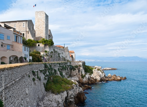 The medieval Grimaldi Tower and city wall of Antibes, France photo