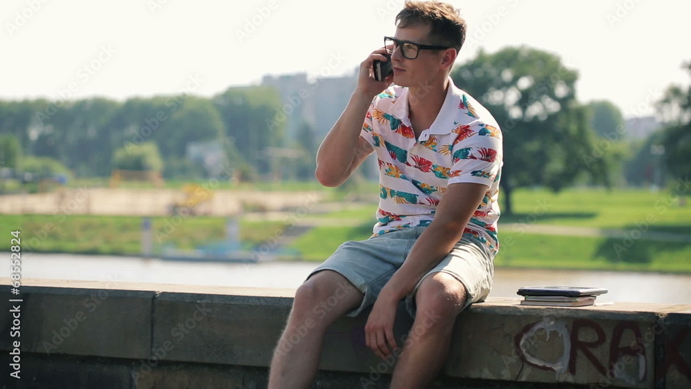 Young trendy man talking on cellphone in the city Young trendy man talking on cellphone in the city