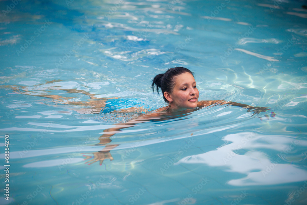 brunette girl in blue swimming suit