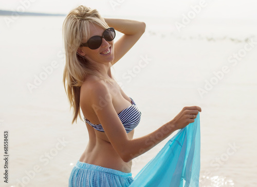 Beautiful young woman enjoying summer on the beach