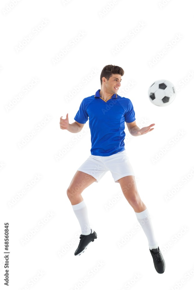 Football player in blue jersey jumping Football player in blue jersey jumping