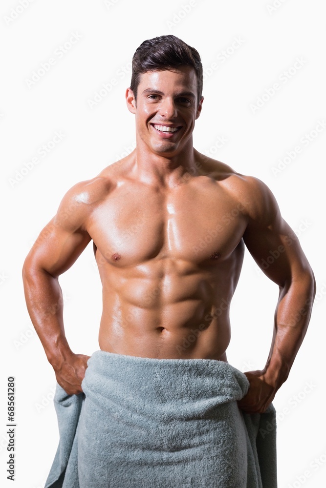Portrait of a smiling shirtless muscular man wrapped in towel Portrait of a smiling shirtless muscular man wrapped in towel