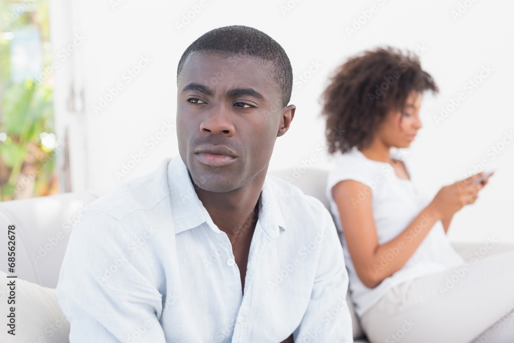 Attractive couple having an argument on couch Attractive couple having an argument on couch