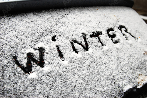 inscription winter on snow on the back window of car photo