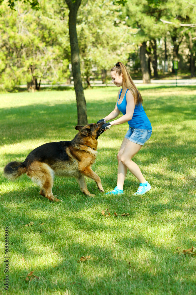 Beautiful young girl with dog in park Beautiful young girl with dog in park