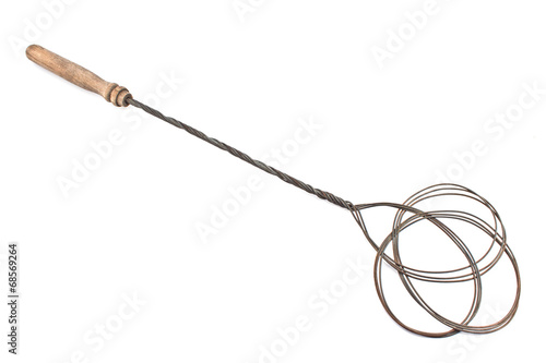 Фотография Old rusty carpet beater isolated on white