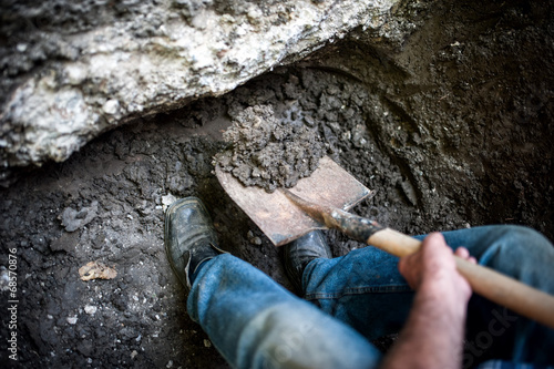 man digging a hole in the ground with shovel and spade photo