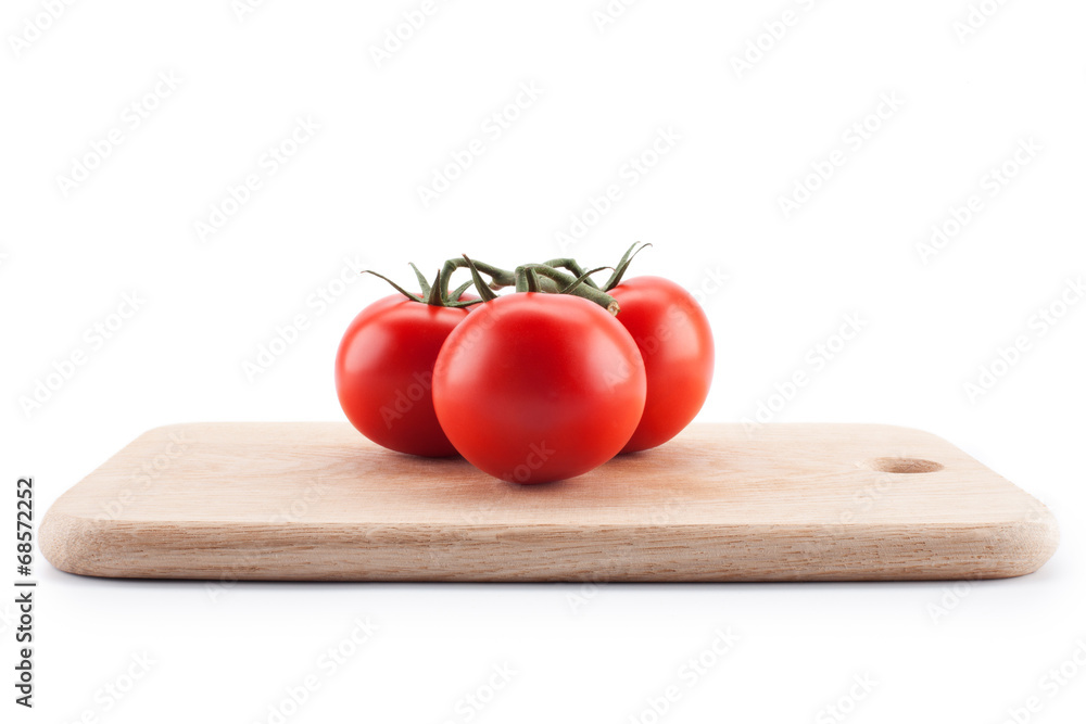Tomatoes lying on a cutting board Tomatoes lying on a cutting board