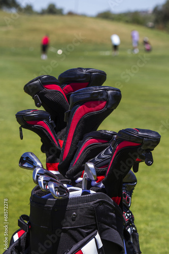 Close view of a professional bag full of golf clubs.