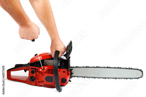 Gasoline chain saw in hand on a white background.