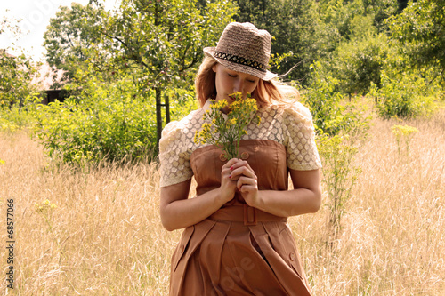 Foto Frau riecht an Blumen