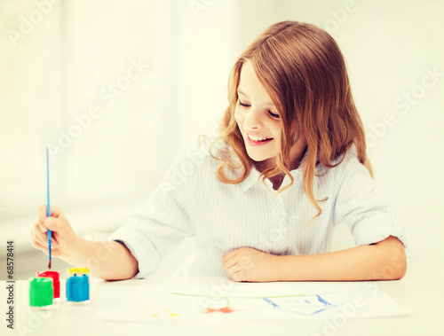 little girl painting at school