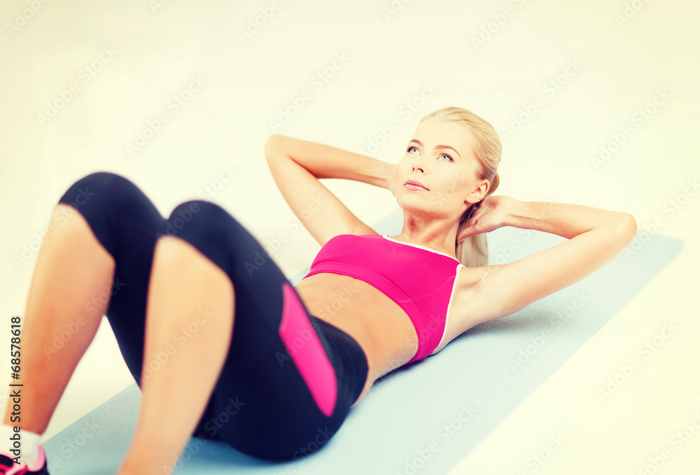 sporty woman doing exercise on the floor