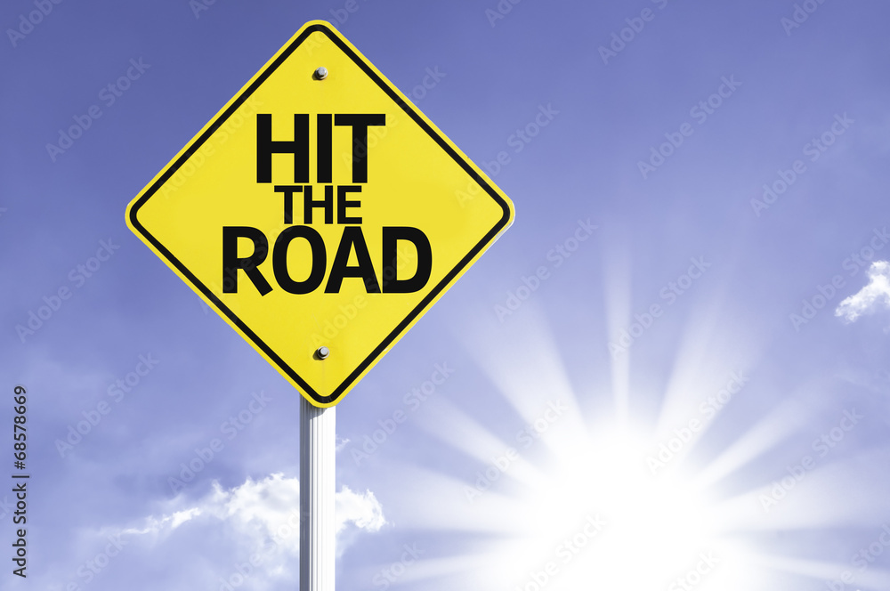 Hit The Road road sign with sun background