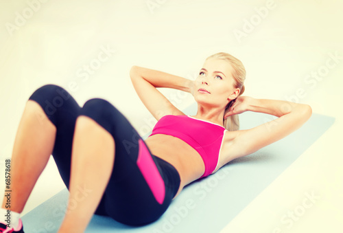 sporty woman doing exercise on the floor