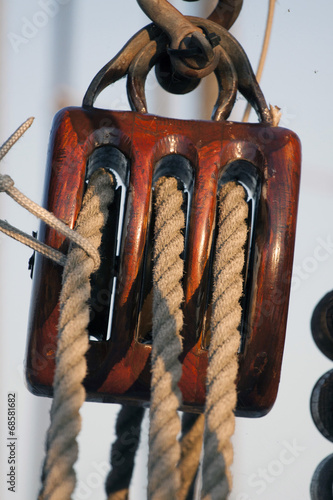 Old pulley of a wooden sailboat.