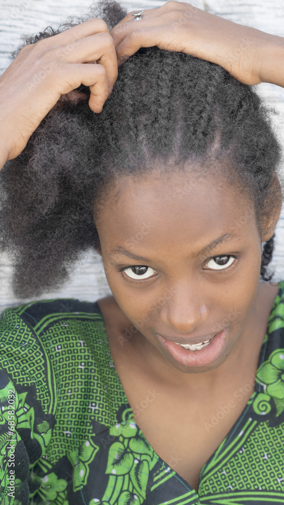 Young Afro beauty breading her hair Stock Photo | Adobe Stock Young Afro beauty breading her hair Stock Photo | Adobe Stock