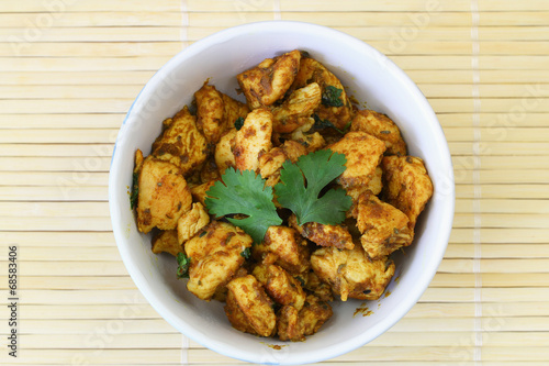 Spicy chicken with curry and coriander
