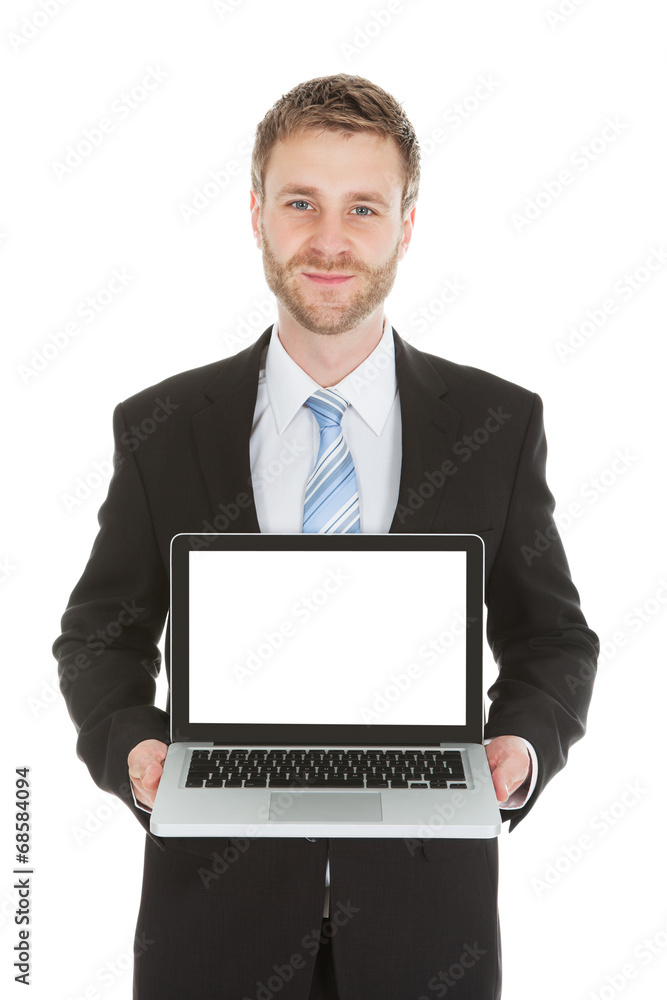 Confident Businessman Displaying Laptop Over White Background Confident Businessman Displaying Laptop Over White Background
