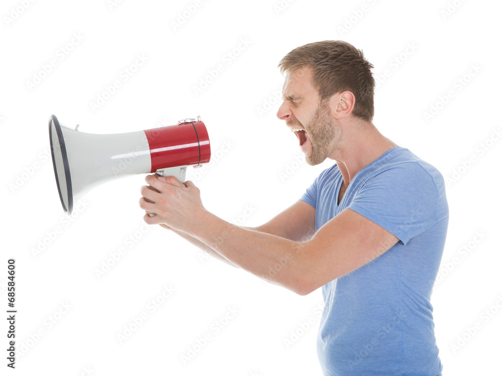 Full Length Of Man Screaming Into Megaphone Full Length Of Man Screaming Into Megaphone