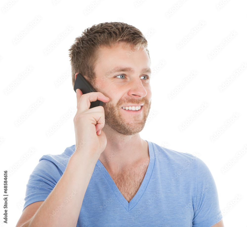 Happy Man Answering Cell Phone While Looking Away Happy Man Answering Cell Phone While Looking Away