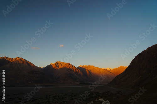 Sunset over Himalayas mountains in Nubra valley near Diskit Gom