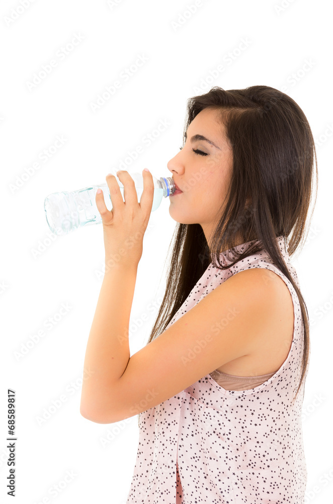 Beautiful young girl drinking water from a plastic bottle Beautiful young girl drinking water from a plastic bottle