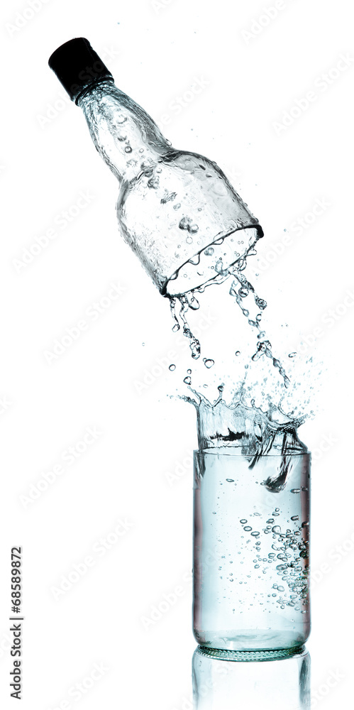 Fresh water splashing out of bottle, isolated on white backgroun Fresh water splashing out of bottle, isolated on white backgroun