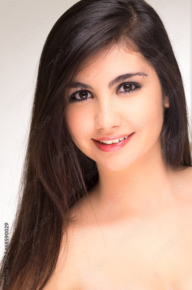 Fototapeta premium Closeup portrait of beautiful young brunette girl posing