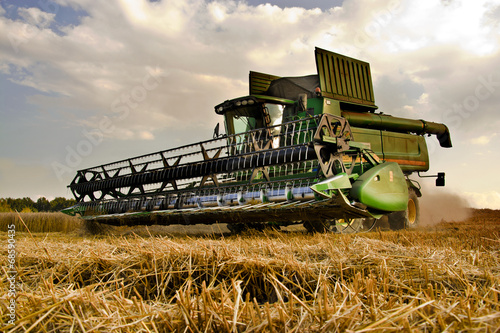 Combine harvester at work harvesting a field of wheat.