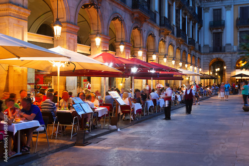 Street restaurants at Placa Reial in night. Barcelona