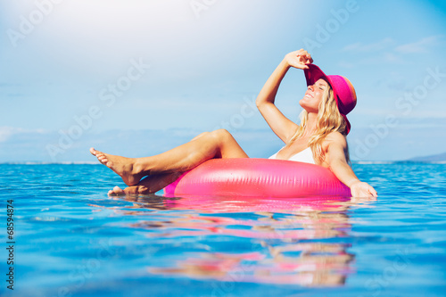 Woman relaxing and floating in the ocean