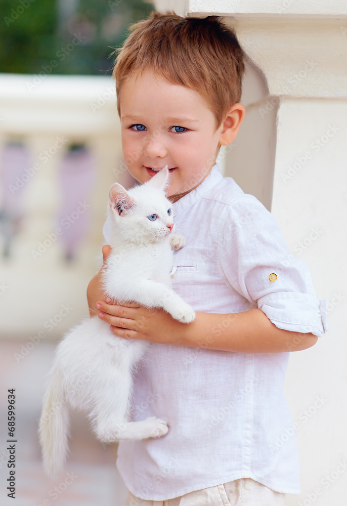cute kid holding white kitten cute kid holding white kitten