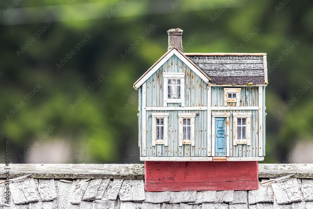 Miniature house on a rooftop