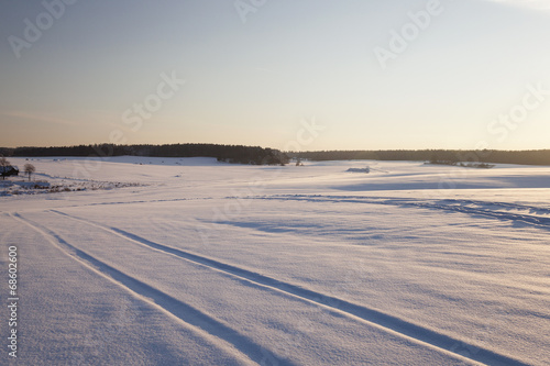  the rural road in an agricultural field in a winter season