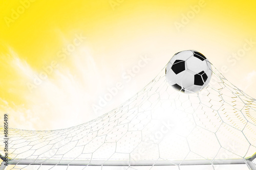 Soccer football in Goal net with Blue sky