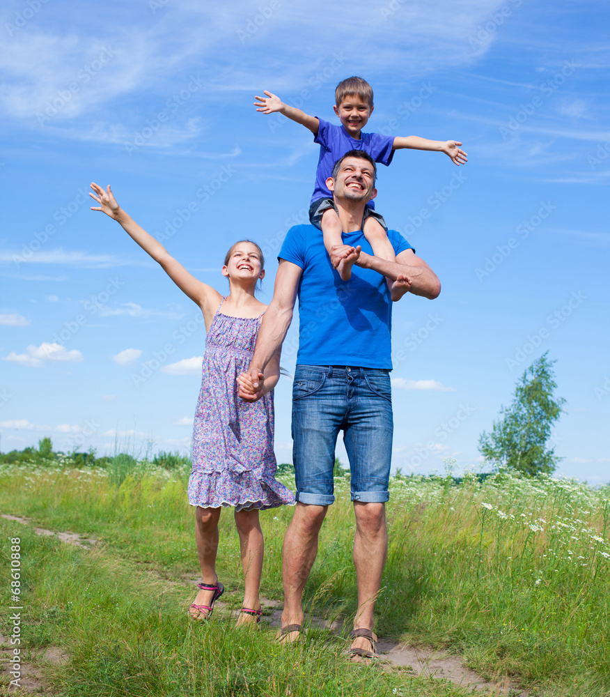 Happy father with kids outdoors against sky Happy father with kids outdoors against sky