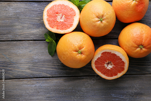 Ripe grapefruits on wooden background