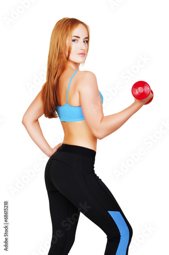 Young fit woman lifting dumbbells on white background