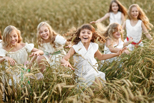 portrait of little girls running on the field © zagorodnaya